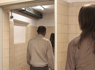 a scene from one of the videos of the installation: people in a public toilet