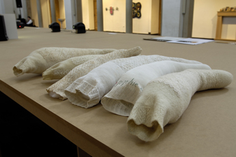 six stuffed woollen stockings on a table of the exhibition