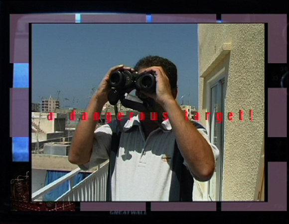 a frame showing a palestinian man watching through a binoculars