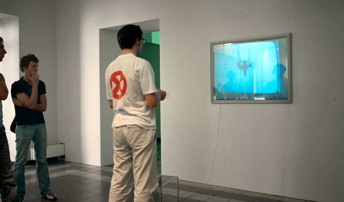 a male visitor playing to the video installation using a videogame joystick