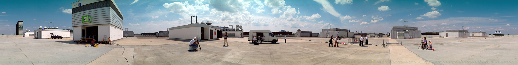 panorama picture of a urban sunny landscape with human figures posing, taking photos and shooting video